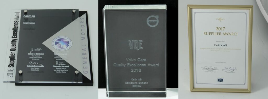 A picture of awards given to Calix AB. General Motors Supplier Quality Excellence Award, Volvo Cars Quality Excellence Award, and KG Knutsson's Supplier Award.